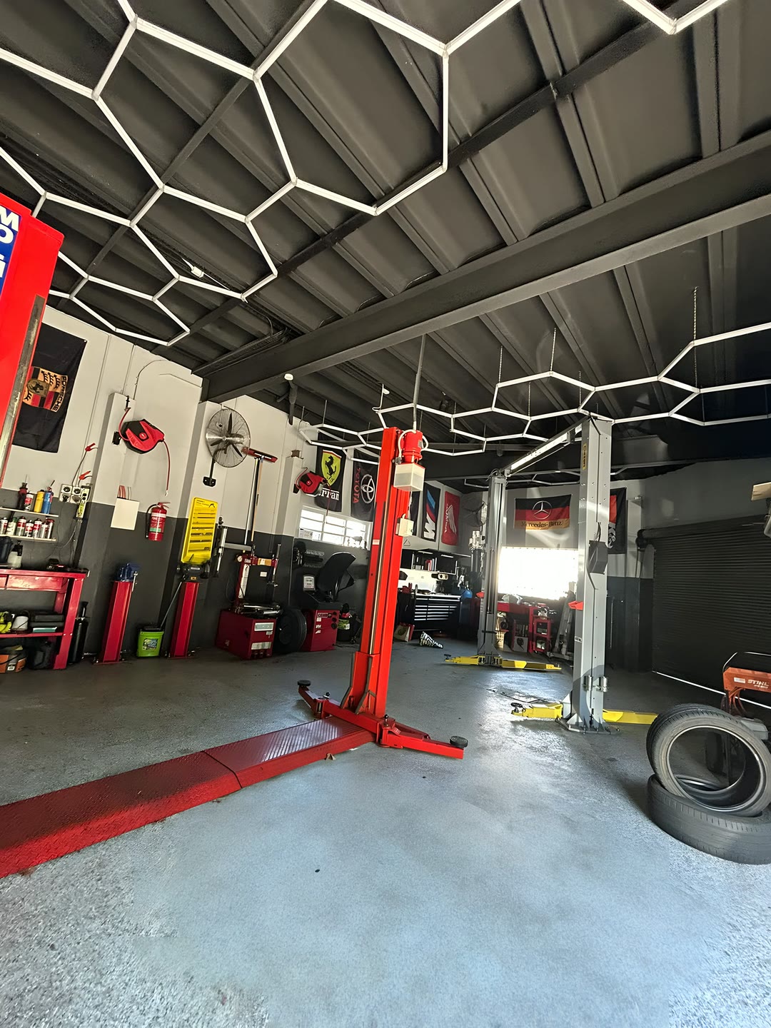 The workshop bays with hoists, tyre machine and tool benches